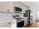 Updated kitchen featuring new stainless appliances, white countertop and kitchen cabinetry at 1889 Cannon St, Decatur, GA 30032