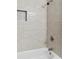 Modern bath tub and shower with neutral color subway tile and built-in niche at 1889 Cannon St, Decatur, GA 30032