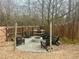 Backyard fire pit area with Adirondack chairs and string lights, surrounded by a wood fence and bare trees at 5305 Redfield Way, Cumming, GA 30028