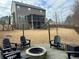 Large backyard featuring a fire pit with Adirondack chairs and a screened-in porch on the house at 5305 Redfield Way, Cumming, GA 30028