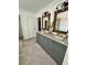 Elegant bathroom featuring a double vanity with granite countertops and framed mirrors with decorative lighting at 5305 Redfield Way, Cumming, GA 30028