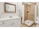 Bathroom with walk-in tiled shower and vanity with a wood-framed mirror at 5305 Redfield Way, Cumming, GA 30028