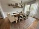 Elegant dining room with hardwood floors, a rustic table set for six, and decorative shelves enhancing the space at 5305 Redfield Way, Cumming, GA 30028