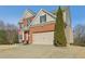 Well-maintained two-story home with attached garage and manicured lawn at 5305 Redfield Way, Cumming, GA 30028