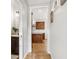 Hallway leading to a well-equipped kitchen with an island, cabinets, and countertops at 5305 Redfield Way, Cumming, GA 30028