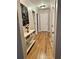 Hallway featuring wood floors, neutral paint, white trim, and decorative furniture that adds a touch of elegance at 5305 Redfield Way, Cumming, GA 30028