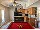 Kitchenette featuring wood cabinets, black appliances, a kitchen island, and a pool table at 5305 Redfield Way, Cumming, GA 30028