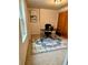 Home office with natural light, a modern desk, and a neutral-toned rug over tile flooring at 5305 Redfield Way, Cumming, GA 30028