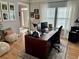 Bright home office featuring hardwood floors, a large desk setup, and comfortable seating for a productive workspace at 5305 Redfield Way, Cumming, GA 30028