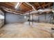 Spacious unfinished basement with exposed ceiling, grey concrete walls, and natural lighting at 72 Diane Ct, Dallas, GA 30157