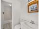 Bathroom view featuring a toilet, cabinet mirror, a shower/tub combo, and tile flooring at 72 Diane Ct, Dallas, GA 30157