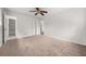 A bedroom with neutral carpet, closet doors, and a ceiling fan with lights at 72 Diane Ct, Dallas, GA 30157