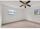 This bedroom has neutral carpet, two windows, and a ceiling fan with lights at 72 Diane Ct, Dallas, GA 30157