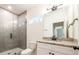 Modern bathroom features granite countertop, glass enclosed shower, and window at 1467 Lockwood Sw Dr, Atlanta, GA 30311