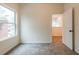 Bright bedroom features neutral carpet, fresh paint, and an open doorway at 1467 Lockwood Sw Dr, Atlanta, GA 30311