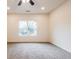 Cozy bedroom with carpet, large window, ceiling fan, and neutral walls at 1467 Lockwood Sw Dr, Atlanta, GA 30311