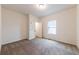 Neutral bedroom with carpet, a large window, white trim, and a closet at 1467 Lockwood Sw Dr, Atlanta, GA 30311