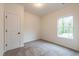 Cozy bedroom with neutral carpeting and natural light from the window at 1467 Lockwood Sw Dr, Atlanta, GA 30311