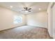 Large bedroom with carpet, ceiling fan, and natural light from a large window at 1467 Lockwood Sw Dr, Atlanta, GA 30311