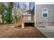 Back of house has a wooden deck, steps and concrete foundation at 1467 Lockwood Sw Dr, Atlanta, GA 30311