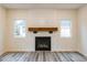 Close up of the fireplace with a wooden mantle and a plank feature wall at 1467 Lockwood Sw Dr, Atlanta, GA 30311