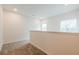 Upstairs hallway with neutral carpet and view of the backyard at 1467 Lockwood Sw Dr, Atlanta, GA 30311