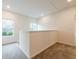 Upstairs hallway features carpet, natural light and neutral walls at 1467 Lockwood Sw Dr, Atlanta, GA 30311