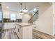 Well-lit kitchen features white cabinets, granite countertops, gray backsplash, stainless steel appliances and a center island at 1467 Lockwood Sw Dr, Atlanta, GA 30311