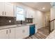 Bright kitchen with stainless steel appliances, white cabinets, granite countertops, subway tile, and view of staircase at 1467 Lockwood Sw Dr, Atlanta, GA 30311