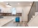 Bright kitchen with stainless steel appliances, granite countertops, and a staircase with a wooden banister at 1467 Lockwood Sw Dr, Atlanta, GA 30311