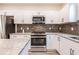 Bright kitchen featuring stainless steel appliances, white cabinets, granite countertops, and subway tile backsplash at 1467 Lockwood Sw Dr, Atlanta, GA 30311