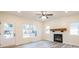 Bright and airy living room featuring hardwood floors, a modern ceiling fan, and a cozy fireplace at 1467 Lockwood Sw Dr, Atlanta, GA 30311