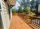 Spacious wooden deck with a view of the private backyard and lush trees at 2360 Elgar Park Pl # 99, Duluth, GA 30096