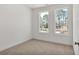 A carpeted bedroom featuring two large windows that offer ample natural light at 2360 Elgar Park Pl # 99, Duluth, GA 30096