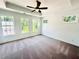 A well-lit carpeted bedroom featuring a ceiling fan and three large windows at 2360 Elgar Park Pl # 99, Duluth, GA 30096