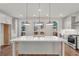 A bright kitchen featuring an island with pendant lighting, white cabinets, and stainless steel appliances at 2360 Elgar Park Pl # 99, Duluth, GA 30096