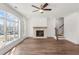 Cozy living room featuring hardwood floors, stone fireplace, large windows, and staircase at 2360 Elgar Park Pl # 99, Duluth, GA 30096