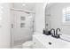 Well-lit bathroom featuring a glass-enclosed shower with subway tile and a modern vanity with black fixtures at 2720 Creekview Nw Pt, Marietta, GA 30064