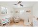 Comfortable Bedroom with a rocking chair, decorative bookshelf, and neutral tones at 2720 Creekview Nw Pt, Marietta, GA 30064