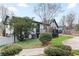 Back exterior view of the home, featuring a deck and yard surrounded by mature trees and landscaping at 2720 Creekview Nw Pt, Marietta, GA 30064