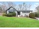 Inviting home featuring a lush, green lawn and charming curb appeal with crisp black trim at 2720 Creekview Nw Pt, Marietta, GA 30064