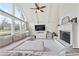 Bright living room featuring a large sectional sofa and a painted white brick fireplace at 2720 Creekview Nw Pt, Marietta, GA 30064