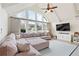 Bright living room featuring a large sectional sofa and a vaulted ceiling with large windows at 2720 Creekview Nw Pt, Marietta, GA 30064