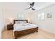 Comfortable main bedroom with a ceiling fan and a window; a dark wood bed frame anchors the space at 2720 Creekview Nw Pt, Marietta, GA 30064