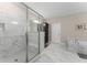 Bright bathroom boasts marble floors and countertops, a glass shower, and a soaking tub at 380 Parkside Meadow Sw Dr, Marietta, GA 30064