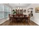 Formal dining room with traditional wood furniture, chandelier, and a large window at 380 Parkside Meadow Sw Dr, Marietta, GA 30064