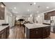 Open kitchen with granite island connects to living area, showcasing dark wood cabinetry and stainless steel refrigerator at 380 Parkside Meadow Sw Dr, Marietta, GA 30064