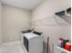 Functional laundry room with a washer, dryer, and storage shelf above at 380 Parkside Meadow Sw Dr, Marietta, GA 30064