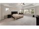 Spacious main bedroom featuring tray ceiling, large windows, neutral color palette, and plush carpeting at 380 Parkside Meadow Sw Dr, Marietta, GA 30064