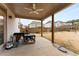 Covered patio with a ceiling fan, grill, worktable, and view of the backyard at 380 Parkside Meadow Sw Dr, Marietta, GA 30064